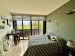 La Isla Bonita`s bedroom with queen bed, desk, balcony with table & chairs